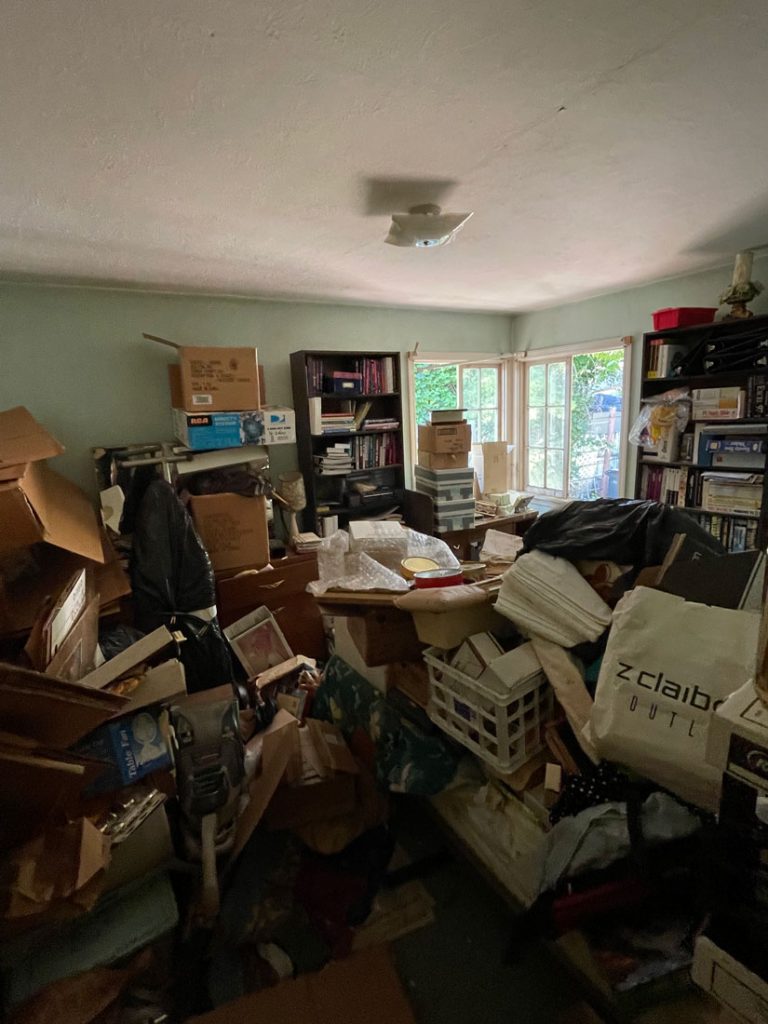 Hoarder home full of personal belongings piling up to the ceiling requires expert environmental hazards services