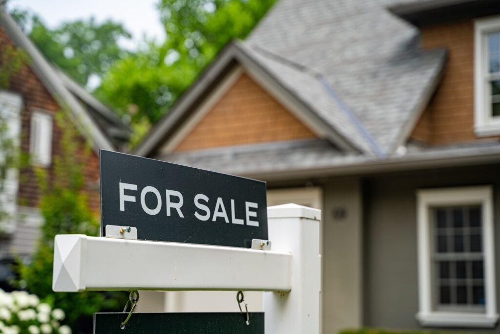 "For Sale" sign in front of a residential home undergoing pre-listing inspection.